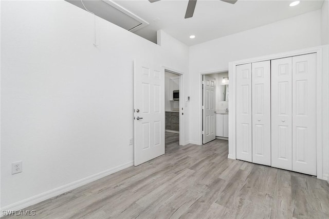 unfurnished bedroom featuring ceiling fan, a closet, and light wood-type flooring