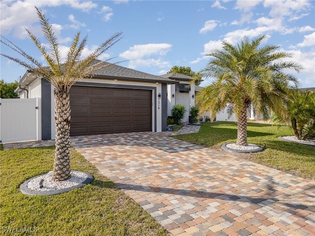 view of front of home with a front lawn and a garage