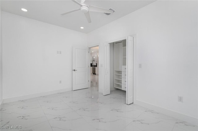 unfurnished bedroom featuring ceiling fan and a closet