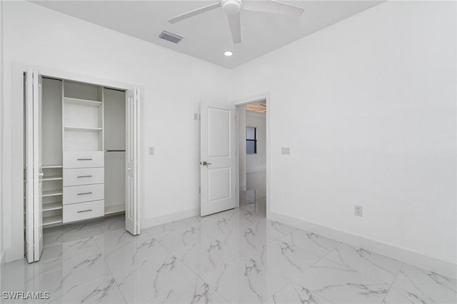 unfurnished bedroom featuring ceiling fan and a closet