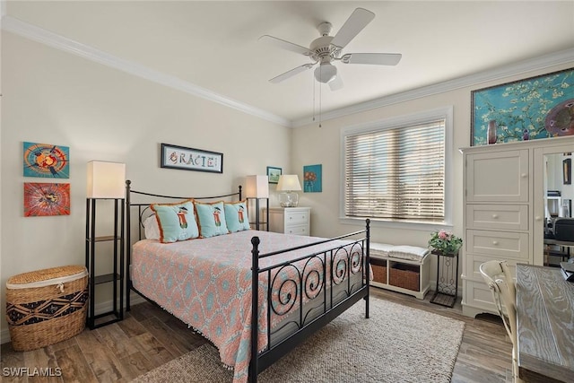 bedroom featuring dark hardwood / wood-style floors, ceiling fan, and ornamental molding