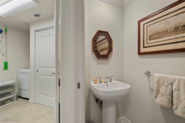 bathroom with washer / dryer, toilet, and sink