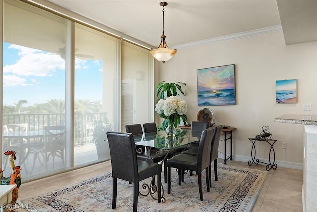 tiled dining space featuring ornamental molding