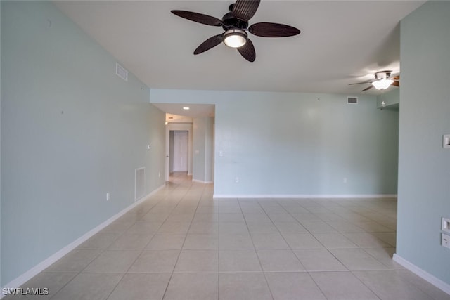 spare room featuring ceiling fan and light tile patterned flooring