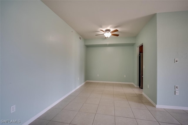 empty room featuring ceiling fan and light tile patterned floors