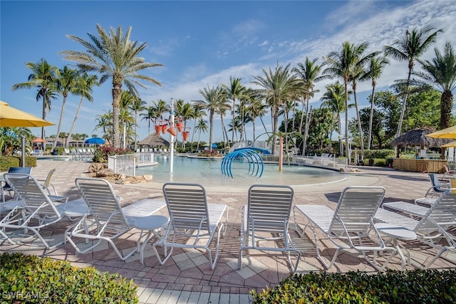 view of swimming pool with pool water feature