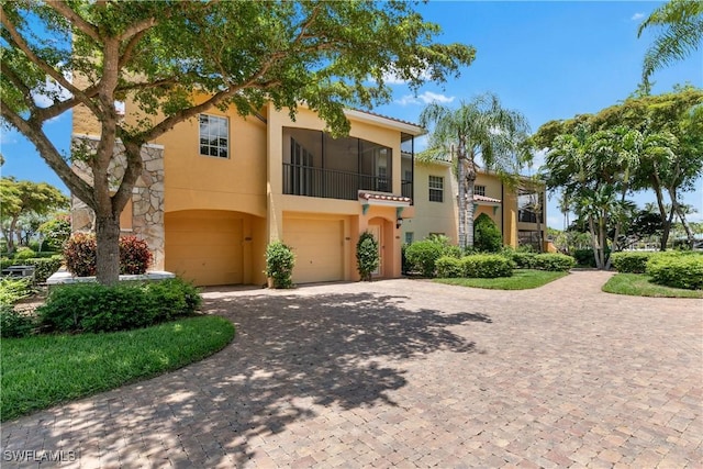 mediterranean / spanish-style house with a garage