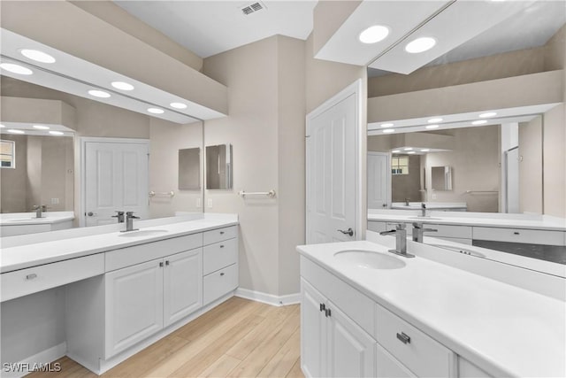 bathroom with vanity and wood-type flooring