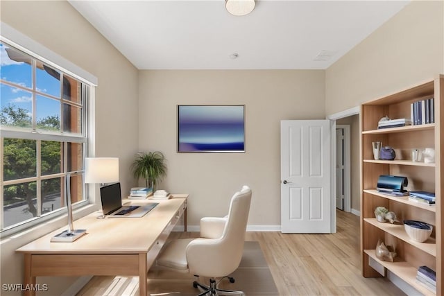 office with light hardwood / wood-style flooring