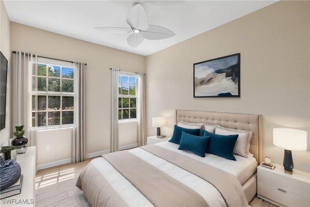 bedroom with ceiling fan and light wood-type flooring