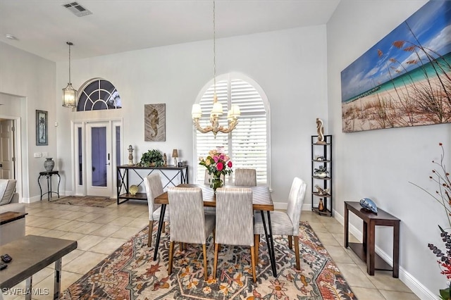 tiled dining area featuring an inviting chandelier