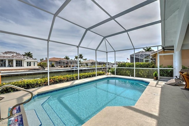 view of pool featuring a water view and glass enclosure