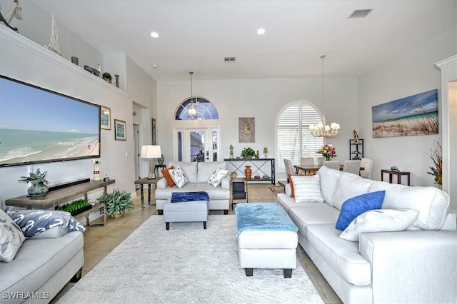 living room featuring a chandelier and light tile patterned floors