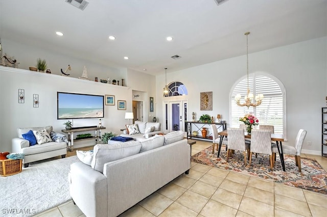 tiled living room featuring french doors and a chandelier