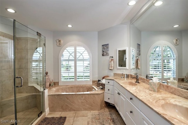 bathroom featuring tile patterned floors, vanity, and plus walk in shower