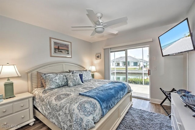 bedroom featuring access to exterior, ceiling fan, and wood-type flooring