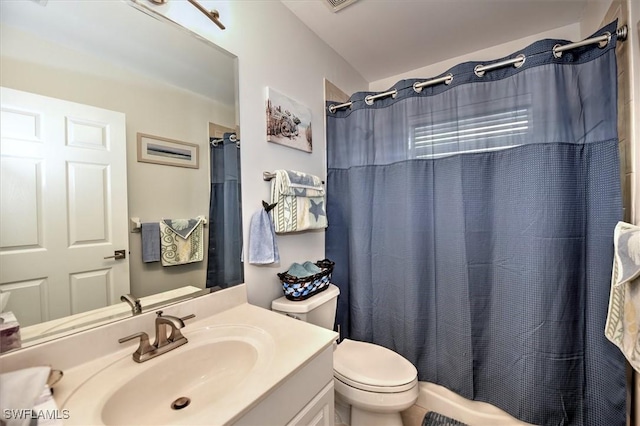 bathroom featuring vanity, curtained shower, and toilet