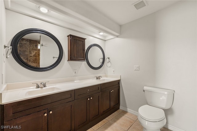 bathroom featuring toilet, tile patterned floors, and vanity