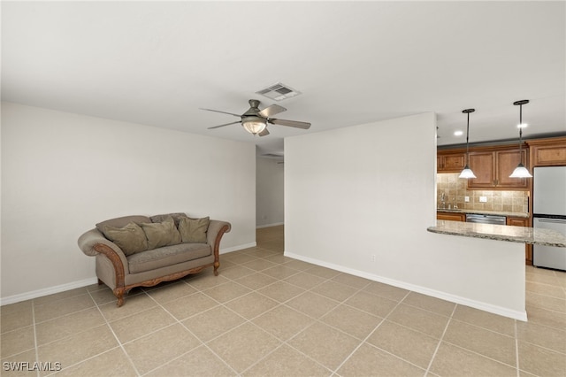 sitting room featuring ceiling fan, sink, and light tile patterned floors