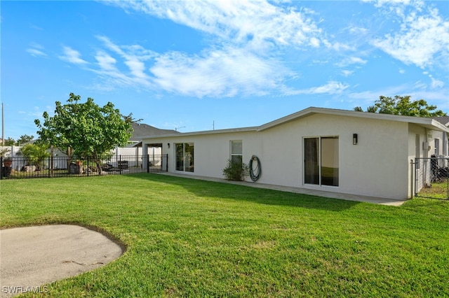 rear view of property with a lawn