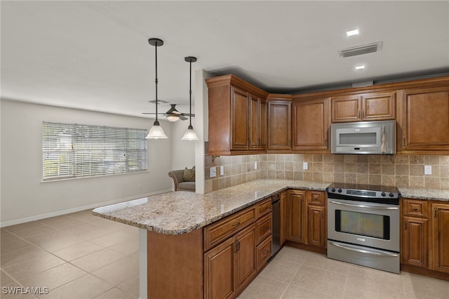 kitchen with appliances with stainless steel finishes, decorative light fixtures, backsplash, and kitchen peninsula