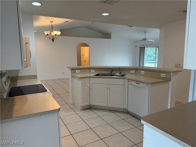 kitchen featuring vaulted ceiling, white dishwasher, sink, white cabinetry, and decorative light fixtures