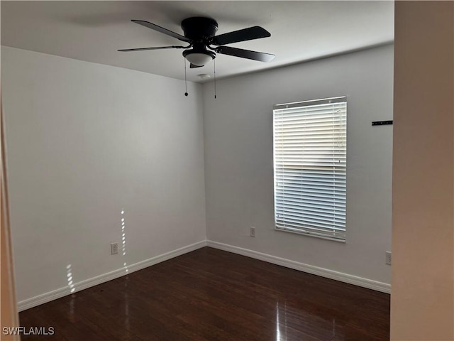 unfurnished room with ceiling fan and dark wood-type flooring