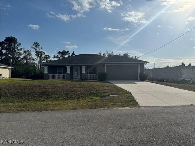 view of front of home with a porch, a front yard, and a garage