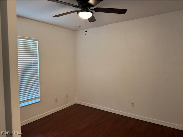 unfurnished room with dark hardwood / wood-style flooring and ceiling fan