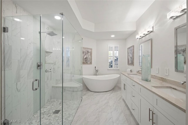 bathroom featuring vanity and shower with separate bathtub