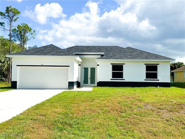 view of front of home featuring a front yard, french doors, and a garage