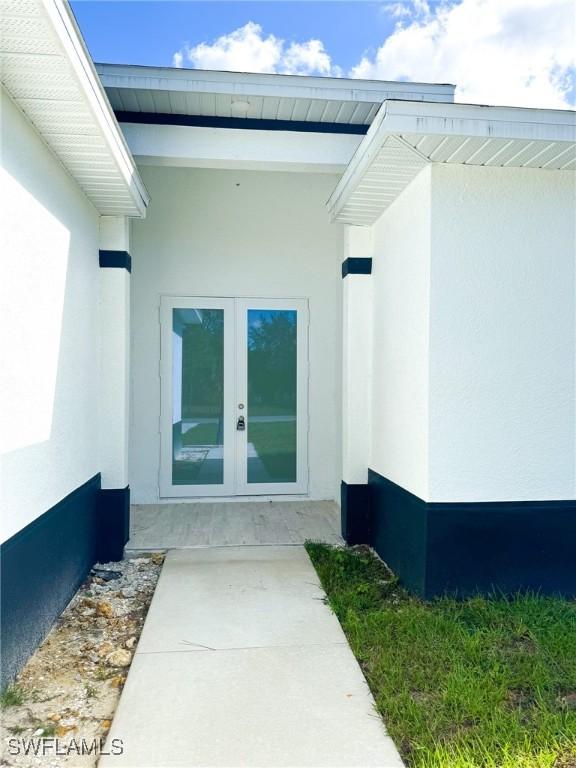 property entrance featuring french doors