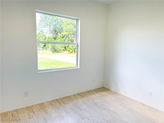 unfurnished room featuring light hardwood / wood-style flooring and a healthy amount of sunlight