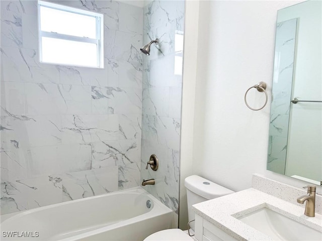 full bathroom featuring vanity, tiled shower / bath combo, and toilet