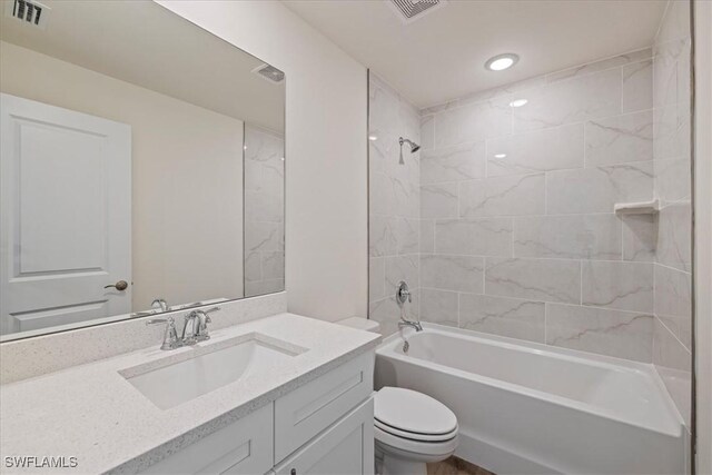 bathroom with visible vents, shower / washtub combination, toilet, and vanity