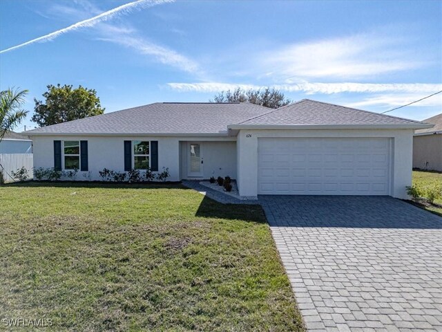 ranch-style house featuring stucco siding, an attached garage, decorative driveway, and a front yard