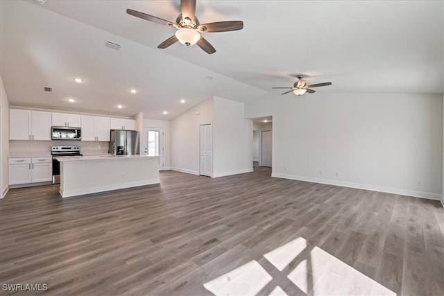 unfurnished living room featuring visible vents, baseboards, lofted ceiling, and wood finished floors