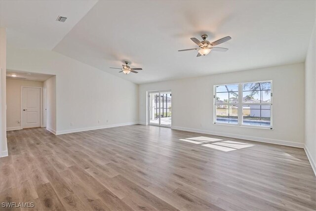 spare room featuring baseboards, visible vents, light wood finished floors, and ceiling fan