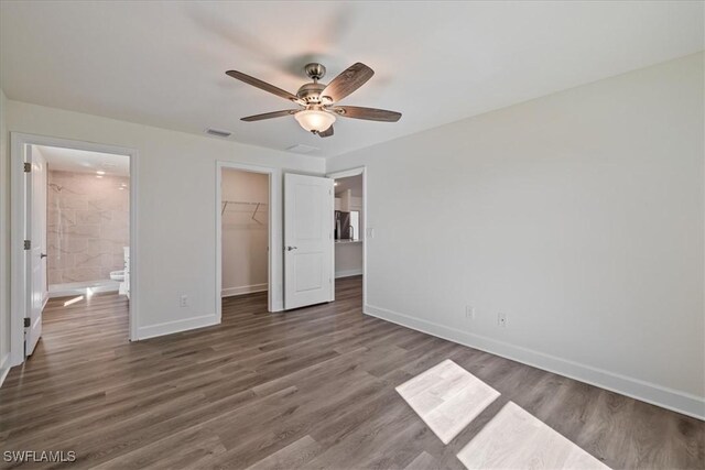 unfurnished bedroom featuring wood finished floors, visible vents, and baseboards