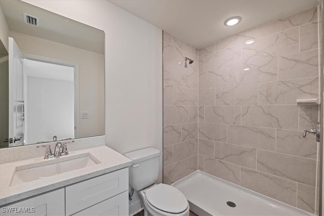 full bathroom featuring visible vents, toilet, a shower stall, and vanity