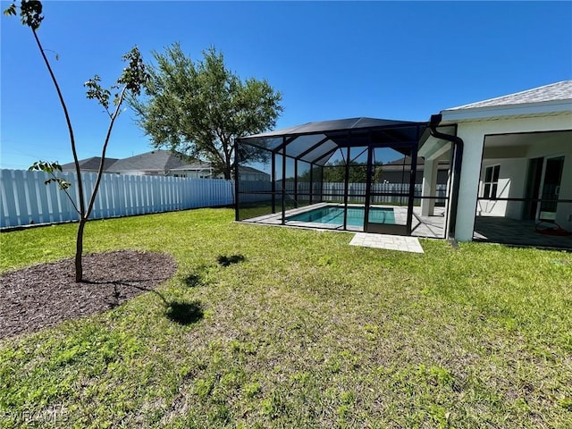 view of yard featuring a lanai, a fenced in pool, and a fenced backyard