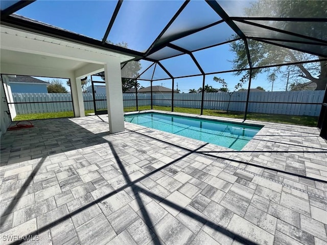 view of swimming pool featuring a lanai, a fenced in pool, a patio, and a fenced backyard