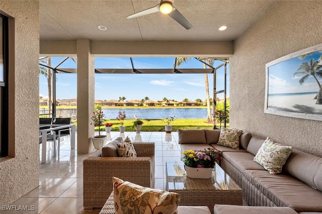 sunroom / solarium with a water view and ceiling fan