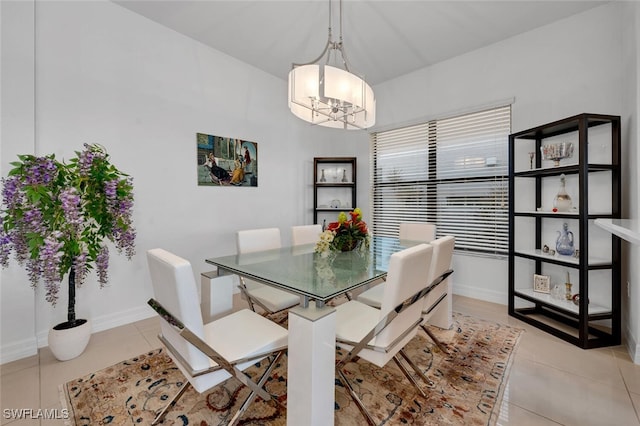 tiled dining room featuring a chandelier