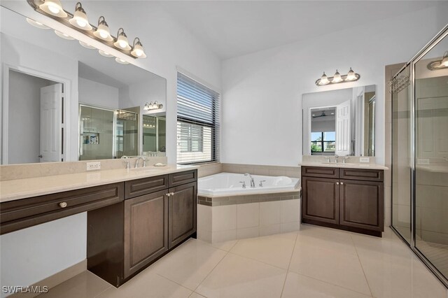 bathroom featuring separate shower and tub, vanity, and tile patterned flooring