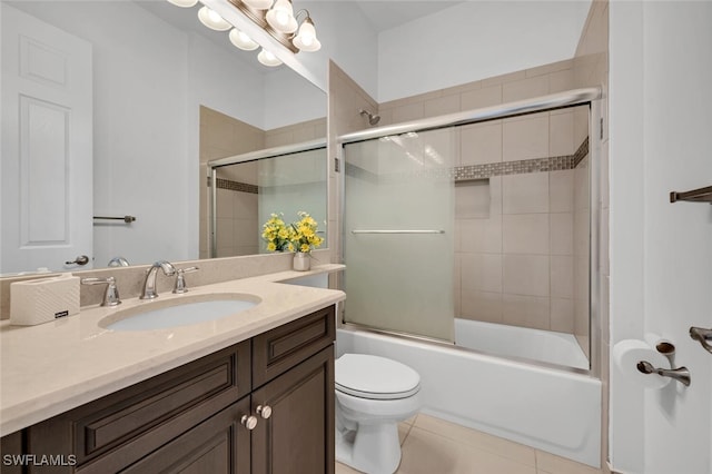 full bathroom featuring vanity, tile patterned floors, enclosed tub / shower combo, and toilet