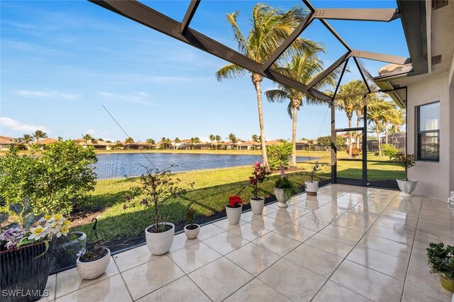 view of patio featuring a lanai and a water view