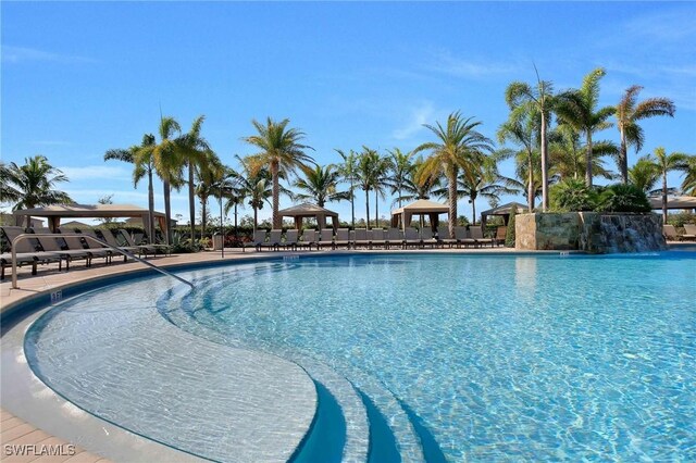 view of pool featuring pool water feature and a gazebo