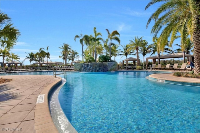 view of swimming pool with a gazebo and a water view