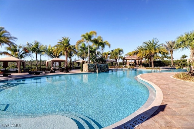 view of swimming pool with a gazebo and a patio area